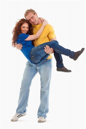 simsearch:400-04702706,k - happy young couple - boy carrying girl in his arms - isolated on white Stockbilder - Microstock & Abonnement, Bildnummer: 400-04180464