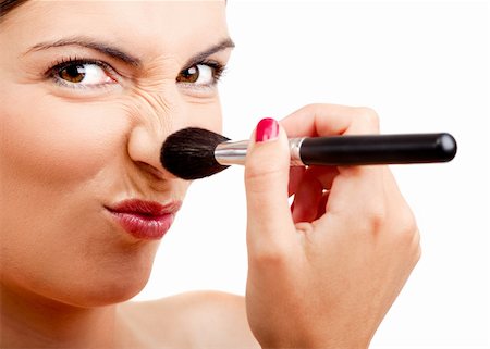 simsearch:400-04895941,k - Portrait of a beautiful woman applying make-up with a brush and making a funny face Fotografie stock - Microstock e Abbonamento, Codice: 400-04180503