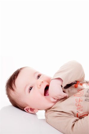 simsearch:400-05009683,k - Portrait of an adorable 6 months old baby boy smiling. White background, studio shot. Photographie de stock - Aubaine LD & Abonnement, Code: 400-04181009