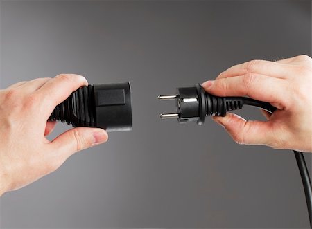 plug in with hand - Man connecting an european shielded extension cord Stock Photo - Budget Royalty-Free & Subscription, Code: 400-04181626