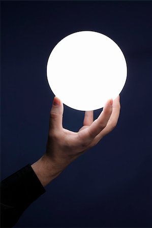 Man holding an illuminated sphere Stock Photo - Budget Royalty-Free & Subscription, Code: 400-04181795