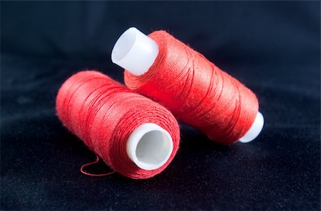 Two spools of red thread on a black background Stock Photo - Budget Royalty-Free & Subscription, Code: 400-04181838