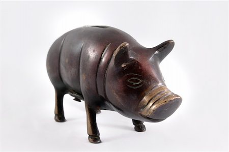 A bronze piggy bank on white background Stock Photo - Budget Royalty-Free & Subscription, Code: 400-04181839