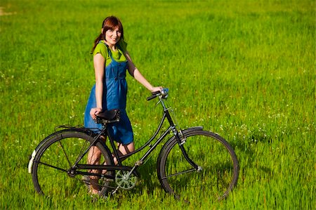 simsearch:400-04201795,k - Happy young woman with a vintage bicycle on a green meadow Stock Photo - Budget Royalty-Free & Subscription, Code: 400-04181984