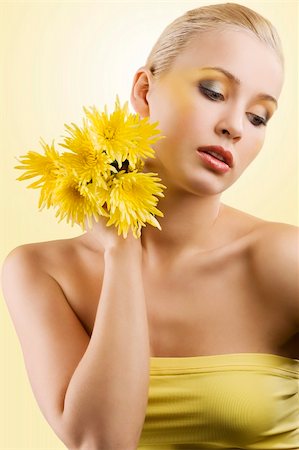 simsearch:400-03914122,k - sweet and beauty blond girl wearing a yellow top keeping yellow flower and looking down. wellness concept Foto de stock - Super Valor sin royalties y Suscripción, Código: 400-04182056