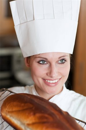 Confident female chef baking bread in a kitchen Stock Photo - Budget Royalty-Free & Subscription, Code: 400-04182657