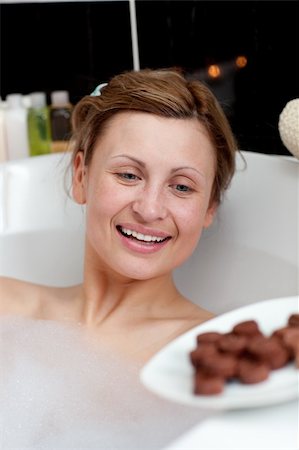 Happy woman eating chocolate while having a bath in a spa center Stock Photo - Budget Royalty-Free & Subscription, Code: 400-04182754