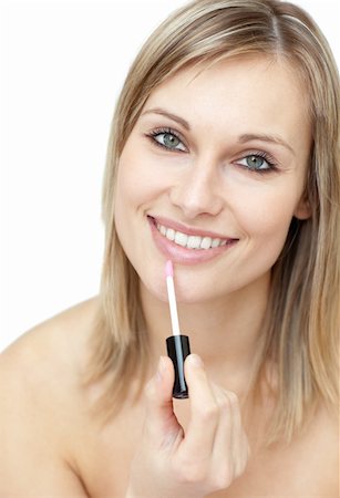 Charming woman putting gloss against a white background Stock Photo - Budget Royalty-Free & Subscription, Code: 400-04182811