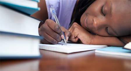 simsearch:400-08296114,k - Close-up of a tired afro-american teen girl studying in a library Stockbilder - Microstock & Abonnement, Bildnummer: 400-04182971