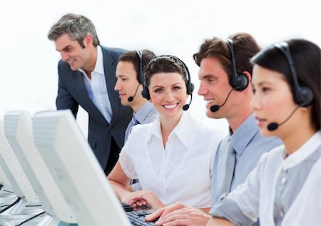 simsearch:400-04188205,k - Self-assured mature manager checking his employee's work in a call-center Stock Photo - Budget Royalty-Free & Subscription, Code: 400-04183007