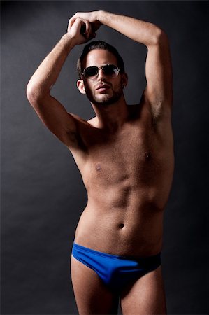 simsearch:400-06065852,k - Young male under wear model wearing glass over black background Stock Photo - Budget Royalty-Free & Subscription, Code: 400-04183354