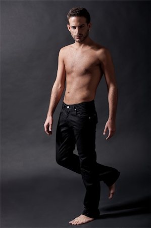 simsearch:400-06065852,k - Fashion male model with black jean over black background Stock Photo - Budget Royalty-Free & Subscription, Code: 400-04183355