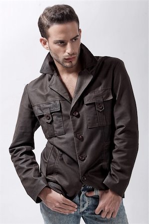 simsearch:400-05912400,k - Young male model with brown jacket over grey background Photographie de stock - Aubaine LD & Abonnement, Code: 400-04183352