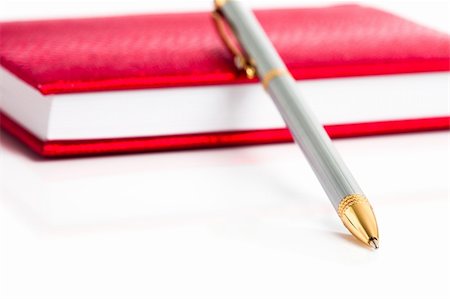 red notebook with silver pen Stock Photo - Budget Royalty-Free & Subscription, Code: 400-04183381