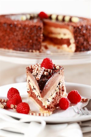 simsearch:400-04575700,k - Delicious chocolate cake garnished with fruits and small chocolate rolls Foto de stock - Super Valor sin royalties y Suscripción, Código: 400-04183394