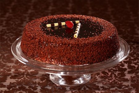 Delicious chocolate cake garnished with fruits and small chocolate rolls Stock Photo - Budget Royalty-Free & Subscription, Code: 400-04183392