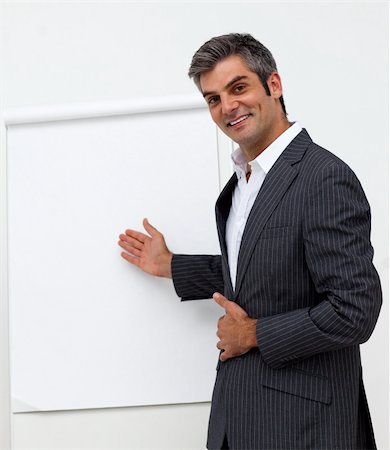 public talk - Self-assured male executive pointing at a board at a presentation Stock Photo - Budget Royalty-Free & Subscription, Code: 400-04183596