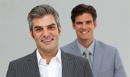 simsearch:400-05118165,k - Happy Businessmen in a line looking at the camera Stock Photo - Budget Royalty-Free & Subscription, Code: 400-04183718