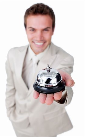 picture man at hotel desk checking in - Attractive businessman showing a service bell isolated on a white background Stock Photo - Budget Royalty-Free & Subscription, Code: 400-04183801