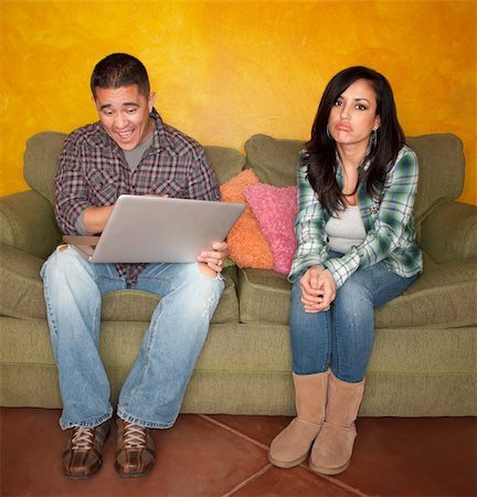 sad email - Hispanic Couple on Green Couch with Computer Woman is Bored Stock Photo - Budget Royalty-Free & Subscription, Code: 400-04194125