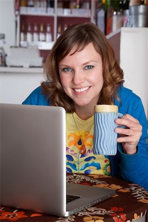 portrait photo of people socialising in a cafe - Pretty lady smiling with laptop at a cafe Stock Photo - Budget Royalty-Free & Subscription, Code: 400-04194204