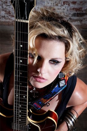 rocker guitarist - Female punk rocker with her guitar in front of a brick background Stock Photo - Budget Royalty-Free & Subscription, Code: 400-04194244