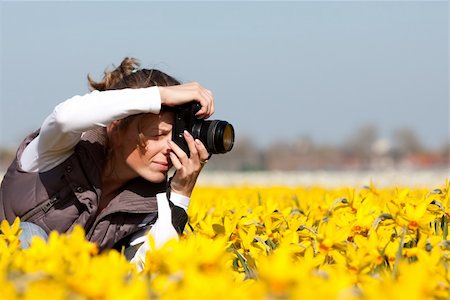 peterkirillov (artist) - Girl photographer making pictures of flowers. Spring in the Netherlands Stock Photo - Budget Royalty-Free & Subscription, Code: 400-04194351