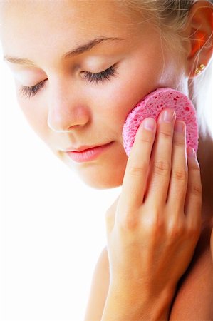 face sponge - Beautiful young woman removing make-up. Isolated over white background. Stock Photo - Budget Royalty-Free & Subscription, Code: 400-04194927