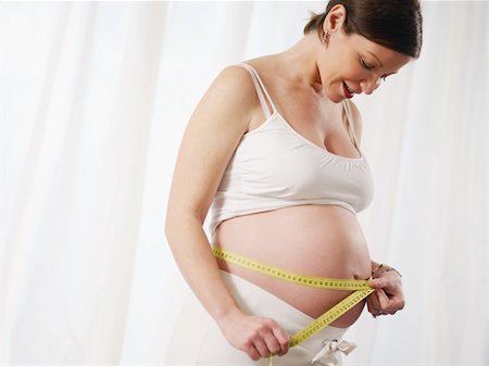 simsearch:649-07437409,k - cropped view of mid adult italian woman measuring waist and smiling. Horizontal shape, side view, copy space Stock Photo - Budget Royalty-Free & Subscription, Code: 400-04194950