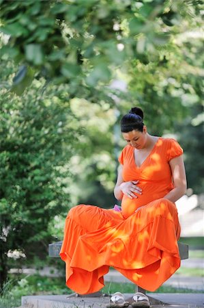 simsearch:400-05230274,k - beautiful young happy pregnant woman outdoor in bright nature in orange dress Foto de stock - Royalty-Free Super Valor e Assinatura, Número: 400-04195010