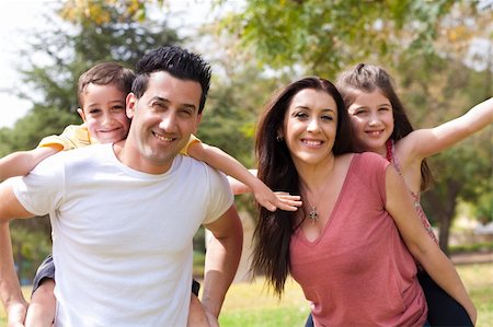 daughter riding on dads shoulders - piggyback to the childrens on the parents back in the  park, outdoor Stock Photo - Budget Royalty-Free & Subscription, Code: 400-04195160