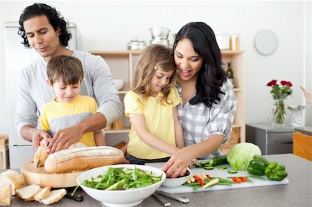 simsearch:400-04206231,k - Positive family preparing lunch together in the kitchen Stock Photo - Budget Royalty-Free & Subscription, Code: 400-04195256