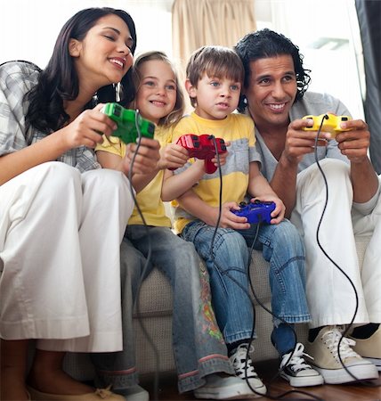 Lively family playing video game  in the living room Stock Photo - Budget Royalty-Free & Subscription, Code: 400-04195265