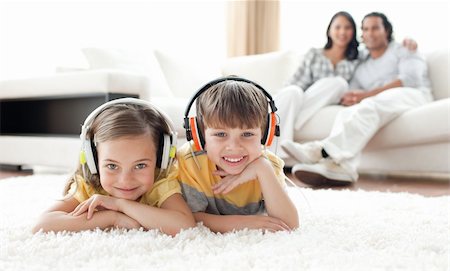 simsearch:400-04200290,k - Adorable siblings listening music with headphones lying on the floor Stock Photo - Budget Royalty-Free & Subscription, Code: 400-04195270