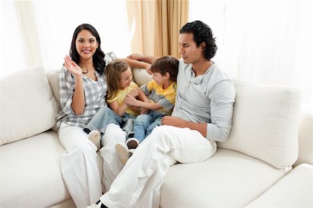 simsearch:400-04192370,k - Merry family having fun in the living room sitting on sofa Stock Photo - Budget Royalty-Free & Subscription, Code: 400-04195287