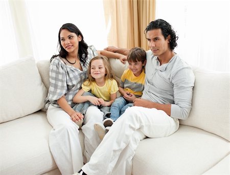 simsearch:400-04192370,k - Portrait of a family sitting on sofa at home Stock Photo - Budget Royalty-Free & Subscription, Code: 400-04195281