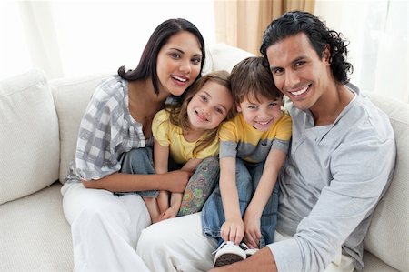 simsearch:400-04193152,k - Close-up of a smiling family sitting on sofa at home Stockbilder - Microstock & Abonnement, Bildnummer: 400-04195282