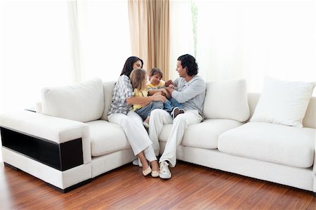 simsearch:400-04192370,k - Animated family having fun sitting on sofa at home Stock Photo - Budget Royalty-Free & Subscription, Code: 400-04195290