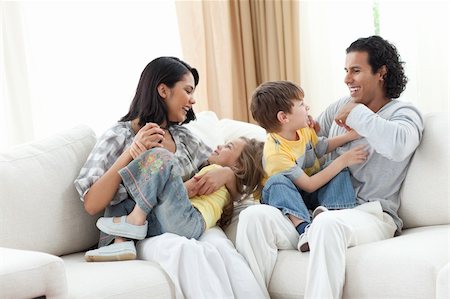 simsearch:400-04192370,k - Merry family playing in the living room at home Stock Photo - Budget Royalty-Free & Subscription, Code: 400-04195291