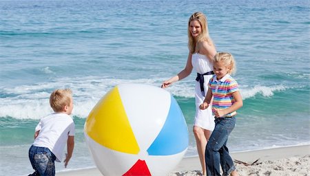 simsearch:400-04114591,k - Cheerful mother and her children playing with a ball at the beach Stock Photo - Budget Royalty-Free & Subscription, Code: 400-04195336