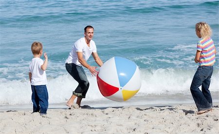 simsearch:400-04114591,k - Happy father and his children playing with a ball at the beach Stock Photo - Budget Royalty-Free & Subscription, Code: 400-04195343