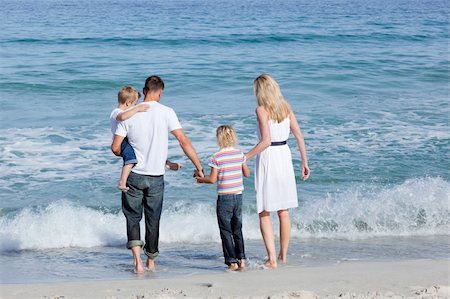 simsearch:400-04062793,k - Happy family walking on the sand at the beach Photographie de stock - Aubaine LD & Abonnement, Code: 400-04195355
