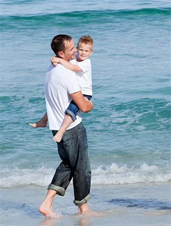 simsearch:400-04062793,k - Cute little boy and his father walking on the sand at the beach Photographie de stock - Aubaine LD & Abonnement, Code: 400-04195356