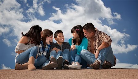 simsearch:400-06366240,k - Hispanic family seated against a cloudy sky Stockbilder - Microstock & Abonnement, Bildnummer: 400-04195513