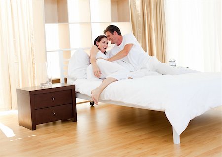 Beautiful lovers sitting on bed at home Photographie de stock - Aubaine LD & Abonnement, Code: 400-04195575