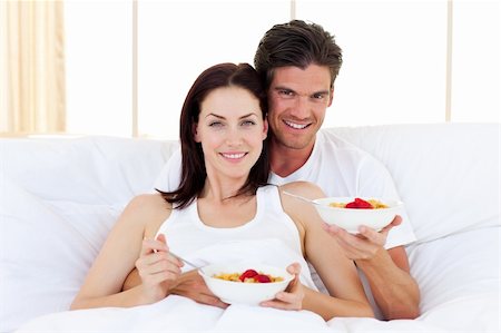 Enamoured couple having breakfast lying in the bed Stock Photo - Budget Royalty-Free & Subscription, Code: 400-04195604