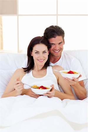 Affectionate couple having breakfast lying in the bed Stock Photo - Budget Royalty-Free & Subscription, Code: 400-04195603