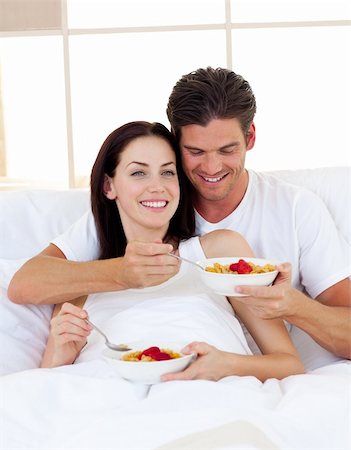 Romantic couple having breakfast lying in the bed Stock Photo - Budget Royalty-Free & Subscription, Code: 400-04195618