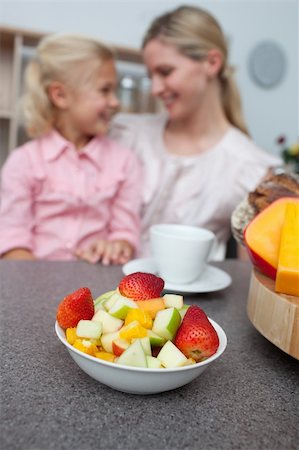 simsearch:400-04206231,k - Blond little girl eating strawberry with her mother in the kitchen Stock Photo - Budget Royalty-Free & Subscription, Code: 400-04195679