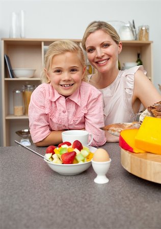 simsearch:400-04206231,k - Caring mother eating fruit with her daughter in the kitchen Stock Photo - Budget Royalty-Free & Subscription, Code: 400-04195684